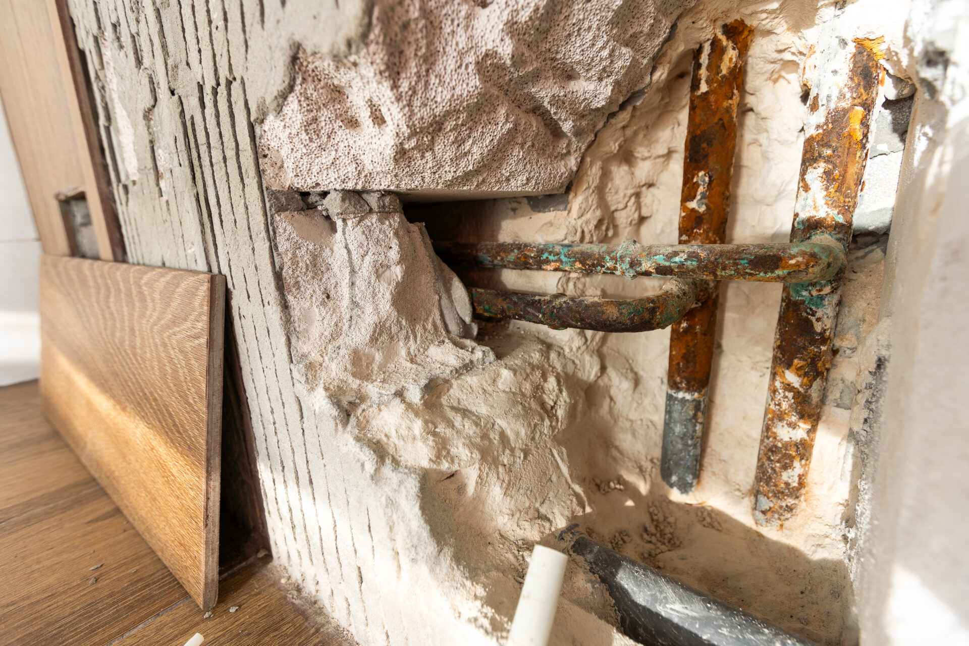 Water damaged wall in an old house. Water damage building interior. wall house broken. Ceiling concrete crack and exposed the rusty steel bar frame.